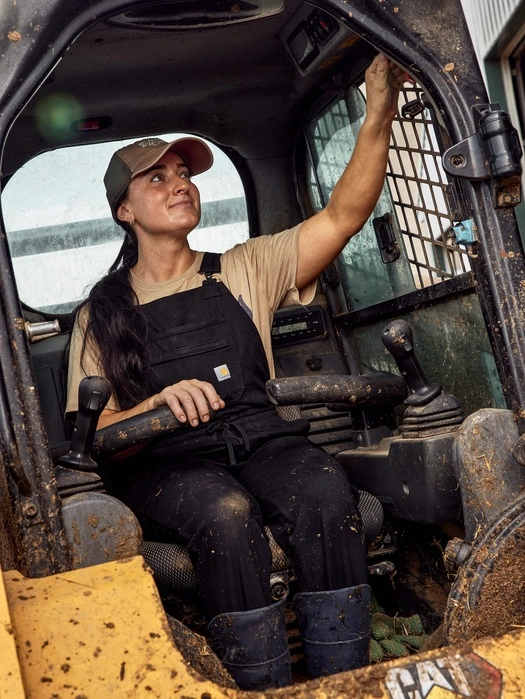 Dairy farmer operating a skid-steer loader